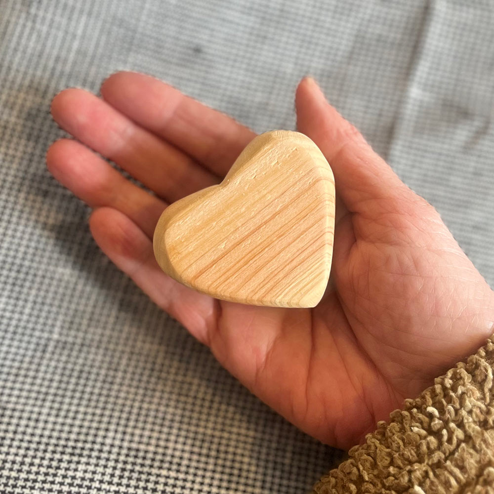 hand-holding-wooden-comfort-heart